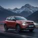 Tata Punch compact SUV driving on a mountain road at dusk, showcasing rugged exterior design and LED headlamps